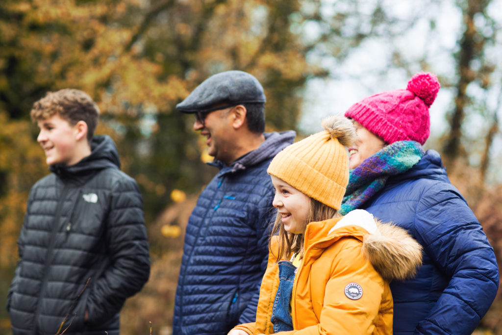 Two adults and two children having fun together outdoors